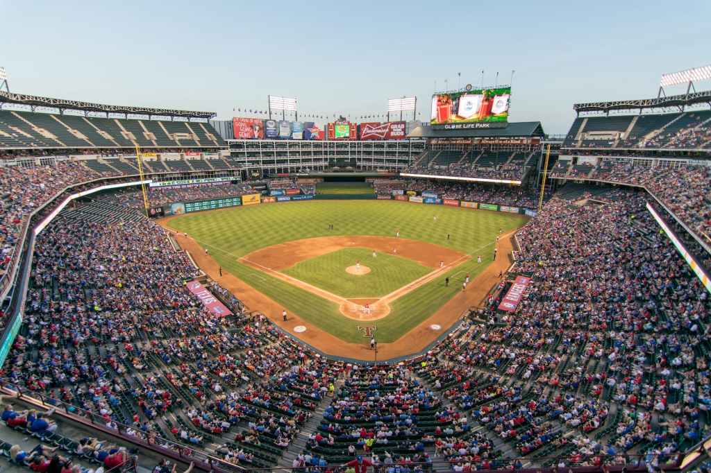 View of a Texas Rangers baseball game at Globe Life Park, as seen from a broadcast booth behind home plate.