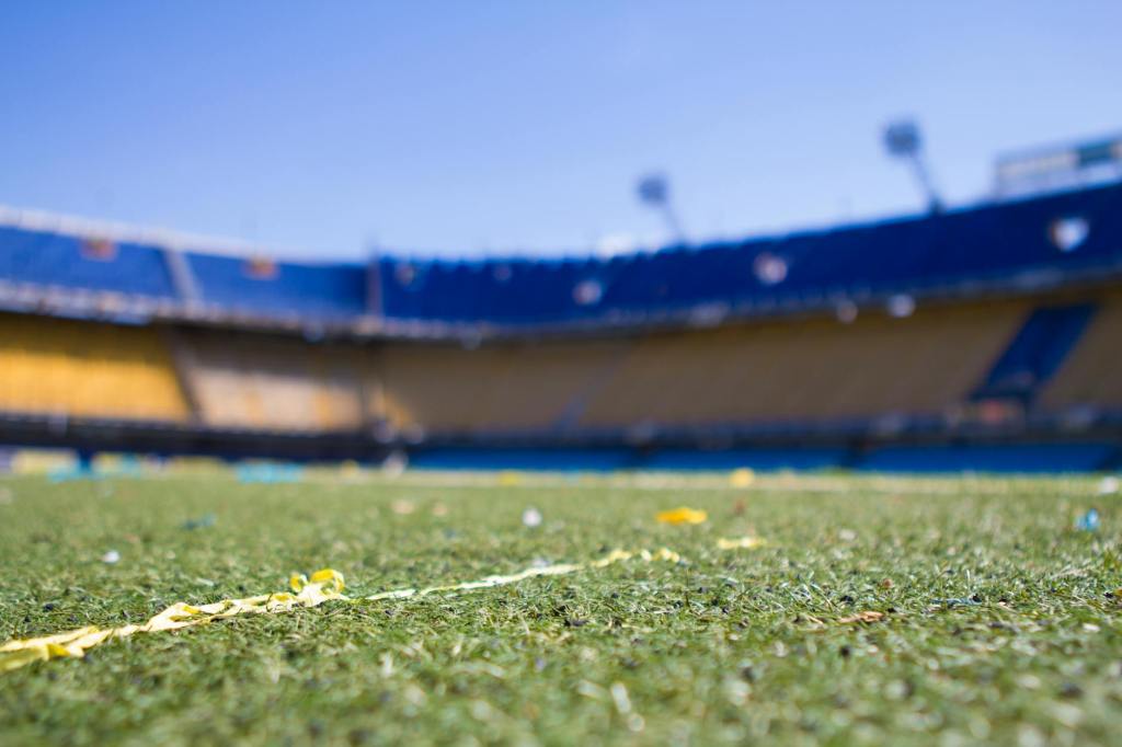 A sports field. The angle is close to the turf and looking up toward the empty stands.